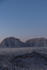 Geological Rock Formations hightlighted by the sun in the early morning hours in South Dakota's Badlands National Park in Spring