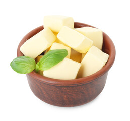 Tasty butter cubes and basil leaves in bowl isolated on white