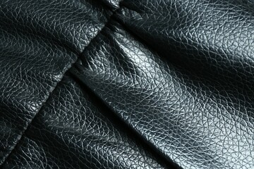 Black leather with seam as background, top view