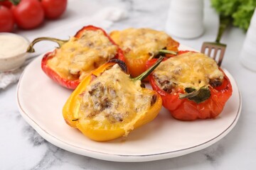 Delicious stuffed peppers on white marble table, closeup