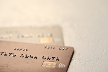 Two credit cards on gray background, closeup. Space for text
