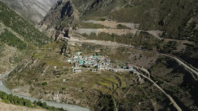 Aerial Drone shot of a small village situated high up in the mountains in Uttarakhand. 