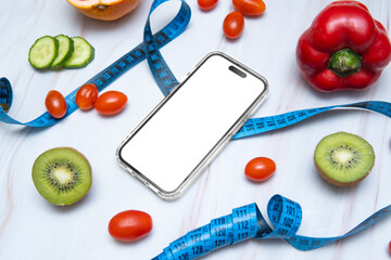 A smartphone mockup placed next to a tailor's measuring tape and an assortment of healthy fruits...