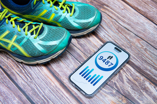 A flat lay photo showcasing a step counting app on a smartphone screen. Conceptual image illustrating healthy habits