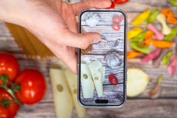 Top-down view of capturing delicious food with a phone camera, showcasing the art of food...