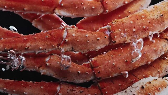 Large snow crab legs are boiled in bubbl boiling