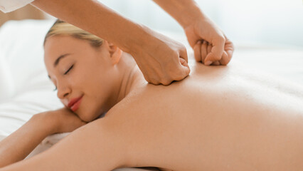 Young Woman Receiving Relaxing Back Massage in Serene Spa Environment