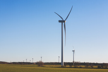 A wind farm with several wind turbines in a field