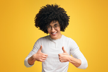 Friendly black man gesturing thumbs up with both hands