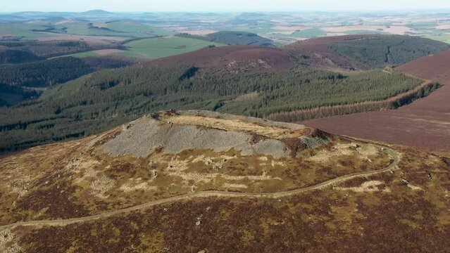 Tap o&rsquo; Noth hillfort Grampian UK. Video fly in from SW to massive vitrified wall of Neolithic core. Outer rampart encloses large Medieval settlement