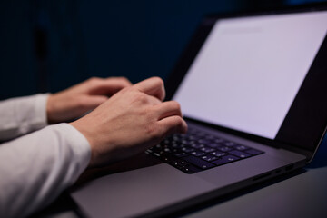 Close-up shot of female hands typing on laptop. Woman fingers tapping on computer keyboard. Work concept