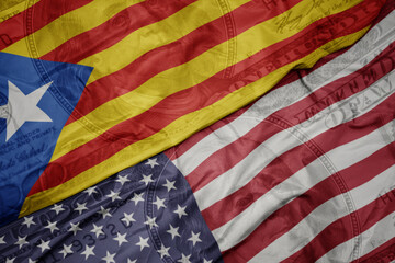 waving colorful flag of united states of america and national flag of catalonia on the dollar money background. finance concept.