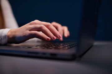 Close-up shot of female hands typing on laptop. Woman fingers tapping on computer keyboard. Work...