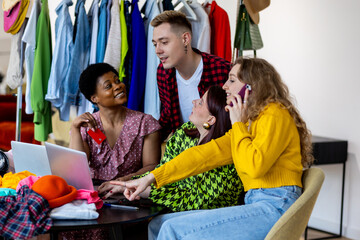 Diverse multicultural group of young women and men shopping online, buying cheap clothes on sales...