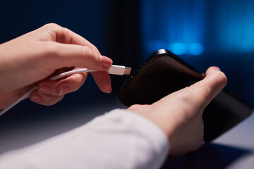 female Hand charges Charge your phone. Close up USB Type-C