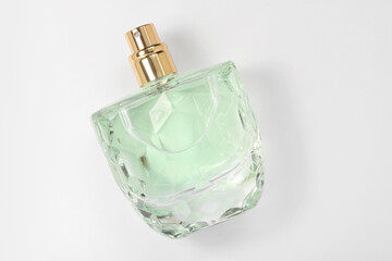 Luxury women's perfume in bottle on white background, top view