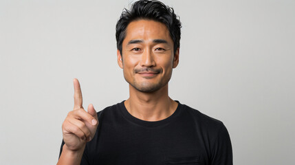 man holding up his hand, pointing to something