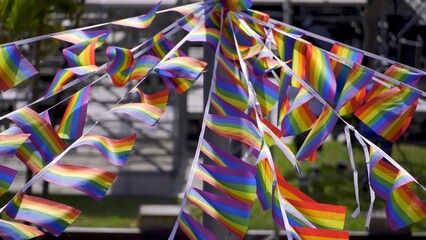 Close up of small festive rainbow flags outdoors