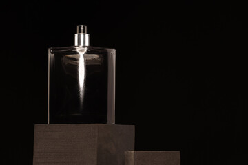 Luxury men`s perfume in bottle against black background, space for text