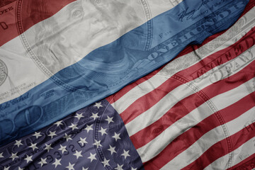 Obraz premium waving colorful flag of united states of america and national flag of luxembourg on the dollar money background. finance concept. macro