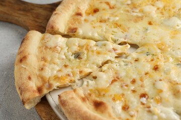 Delicious cheese pizza on light grey table, closeup