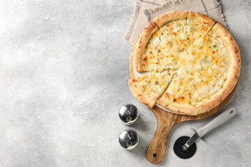 Delicious cheese pizza and cutter on light grey table, flat lay. Space for text