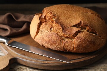 Freshly baked sourdough bread on wooden table, closeup