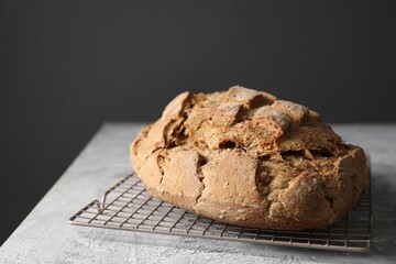 Freshly baked sourdough bread on grey table, closeup