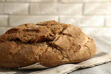 Freshly baked sourdough bread on grey table, closeup