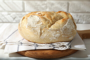 Freshly baked sourdough bread on white table
