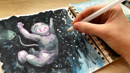 POV drawing astronaut in outer space. Painting dreams with watercolor. Aquarelle sketchbook. Using white gel pen. Illustration of cosmos. Film grain texture. Soft focus. Blur