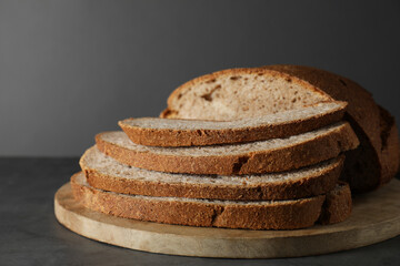 Freshly baked cut sourdough bread on grey table, closeup