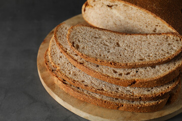 Freshly baked cut sourdough bread on grey table, closeup