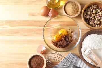 Ingredients for homemade dough on wooden table, flat lay. Space for text