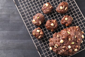 Raw chocolate dough with nuts on black table, top view. Space for text