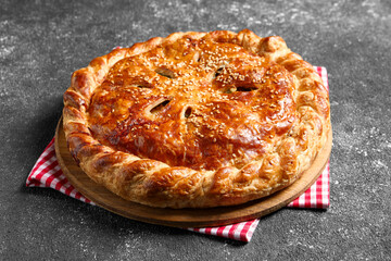 Tasty homemade pie with filling on grey table