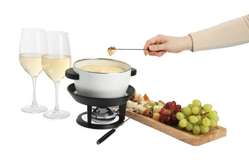 Woman dipping walnut into fondue pot with melted cheese on white background, closeup