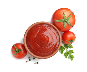Tasty ketchup in bowl, parsley, peppercorns and fresh tomatoes isolated on white, top view