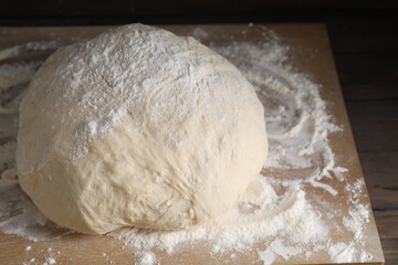 Raw homemade dough on wooden table, closeup