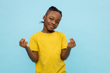 Boy in yellow tshirt standing on blue background and gesticulating - obrazy, fototapety, plakaty