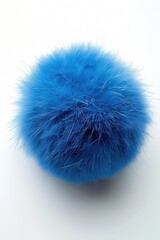 A fluffy blue fur ball on a white surface, suitable for various design projects