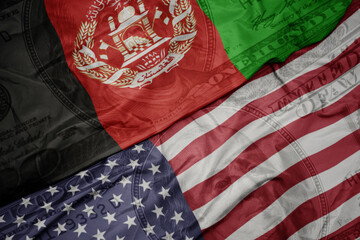 waving colorful flag of united states of america and national flag of afghanistan on the dollar...