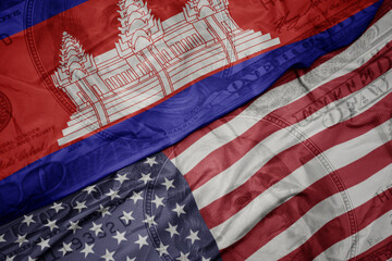 waving colorful flag of united states of america and national flag of cambodia on the dollar money background. finance concept.