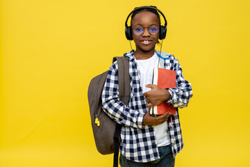 African american boy with backpack and book in hands