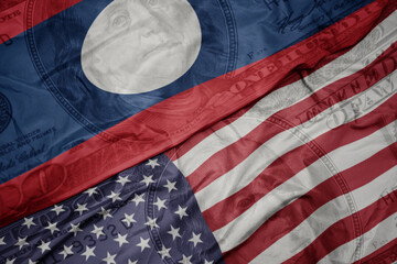 waving colorful flag of united states of america and national flag of laos on the dollar money...