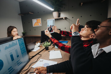In a well-lit office, a diverse group of colleagues enjoys a fun moment by taking a selfie together during a work break.