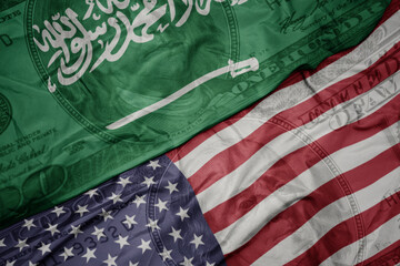 waving colorful flag of united states of america and national flag of saudi arabia on the dollar...