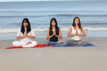 practice yoga lotus pose to meditation with summer vacation on the beach feeling so happiness and cheerful,Travel in tropical beach in Thailand,vacations and relaxation Concept