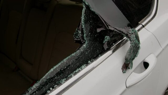 Shattered glass on vehicle hints at recent theft scattered fragments prevalence of car-related crimes. Such instances disrupt lives individuals foster atmosphere distrust insecurity in neighborhood.