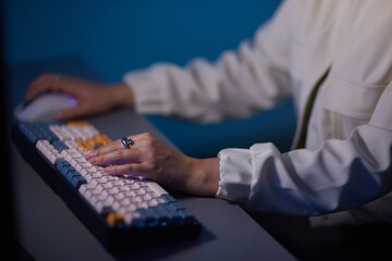 a person is typing on a keyboard with a ring on their finger